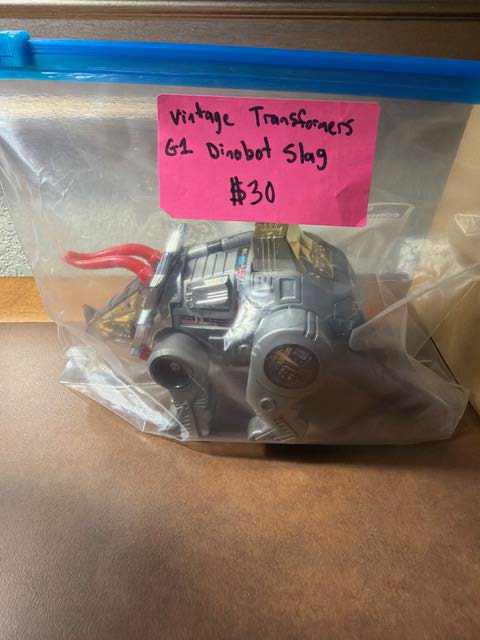 Vintage Transformers G1 Dinobot Slag packaged in a plastic bag with a price tag of $30