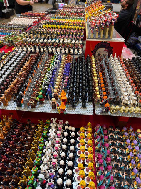 A vibrant display of various action figures and collectibles arranged in neat rows, showcasing a wide array of colors and designs.